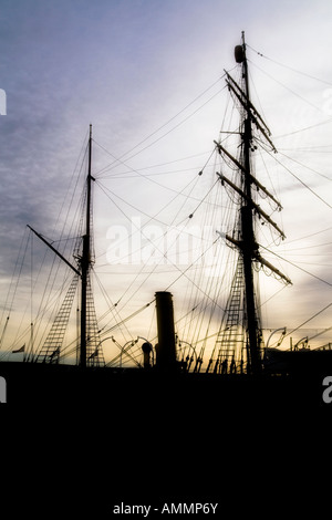 Silhouette of the RRS Discovery research ship at sunset in Dundee,UK Stock Photo