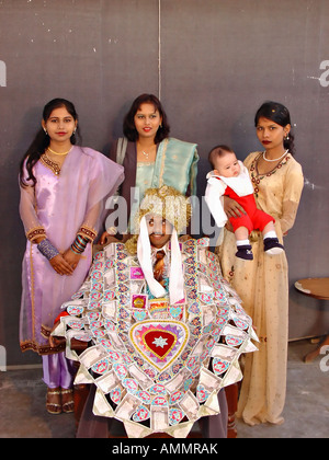 Christian (catholic) wedding in Pakistan groom wearing garland of money with his three sisters Stock Photo