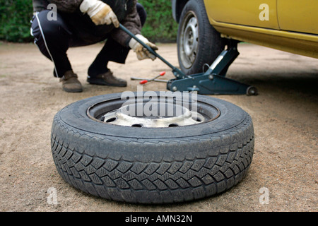 Man changing a tire Stock Photo