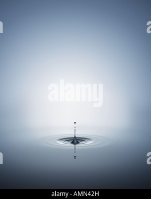 A ripple of water with drops above it Stock Photo