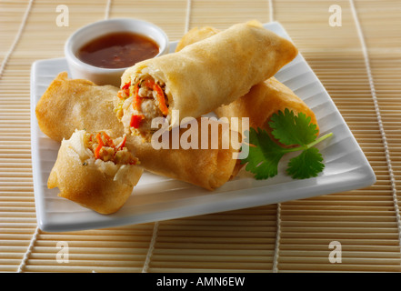 Oriental spring rolls filled with chicken, vegetables with a chilli dipping sauce Stock Photo