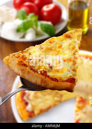 Pizza slice topped with 3 cheeses. A Margarita Neapolitan Pizza Stock Photo