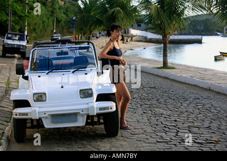 beautiful women with a buggy car in the typical brazilian city of buzios near rio de janeiro in brazil Stock Photo