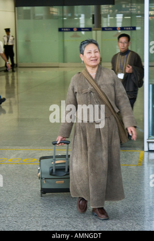 Middle Aged Korean Woman Arriving in Hong Kong International Airport HKG Stock Photo