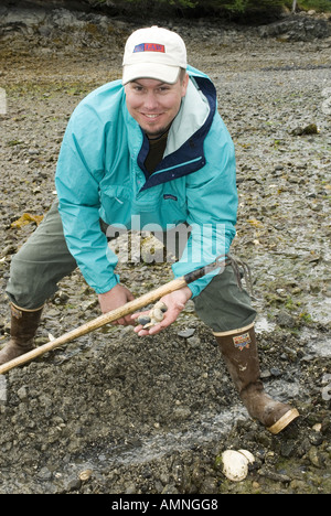 ALASKA MAN DIGGING FOR BUTTER CLAMS KACHEMAK BAY NEAR HOMER Stock Photo