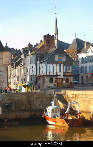 Honfleur Normandy France. Fishing Boat in outer harbour with town behind Stock Photo