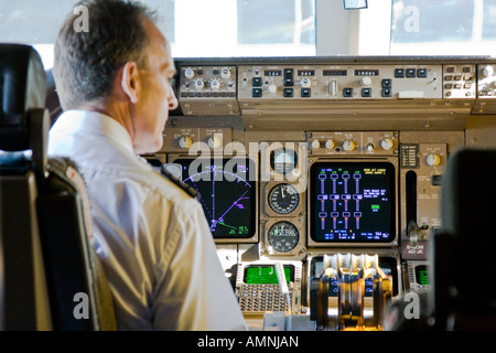Captain and Crew in the Cockpit of a Cathay Airway 747 Boeing Commercial Jet Airplane Stock Photo