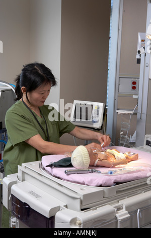 Nurse Simulating Intensive Care Work on Mannequin Stock Photo