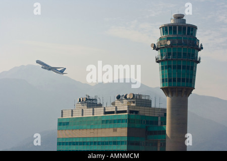 Departing Flight and Conning Tower HKG Hong Kong International Airport Stock Photo
