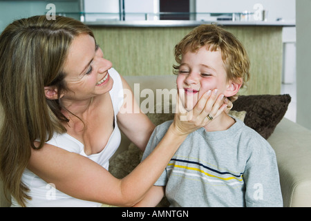Mother Squeezing Son's Cheeks Stock Photo