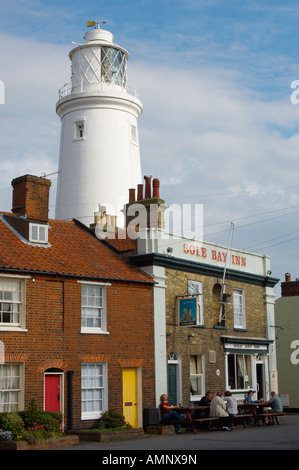 Adnam's Sole Bay brewery pub with Southwold lighthouse behind, Suffolk East England. Stock Photo
