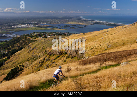 Cyclist, Port Hills, river estuary, New Brighton Beach in Christchurch, Canterbury, East Coast, South Island, New Zealand. Stock Photo