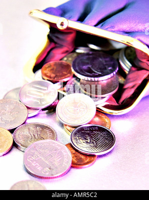 Coins falling into a purse Stock Photo - Alamy