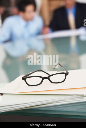 Eyeglasses on Table in Boardroom Stock Photo