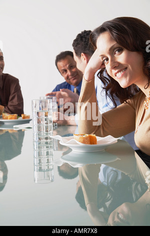 Business People with Snacks in Boardroom Stock Photo