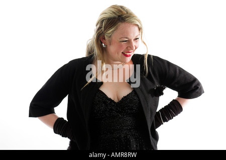 Studio shot of beautiful young blonde woman in 1950s style black evening wear Stock Photo