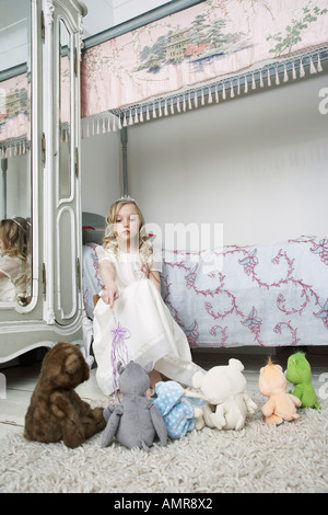 Girl Playing with Toys in Bedroom Stock Photo