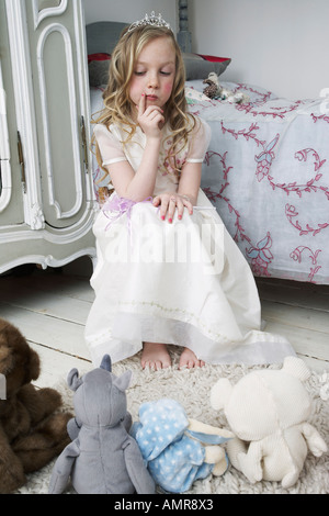 Girl Playing with Toys in Bedroom Stock Photo