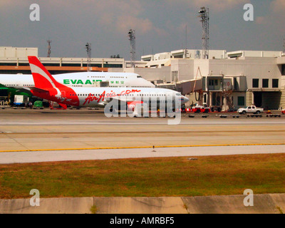 Budget airline Air Asia Boeing 737 parked next to Eva Air Boeing 747 Bangkok International Airport Don Mueang Thailand Stock Photo