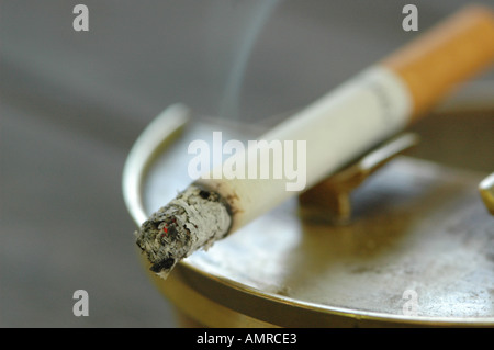 Burning cigarette in ashtray, close-up Stock Photo