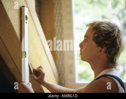 Carpenter using level tool Stock Photo