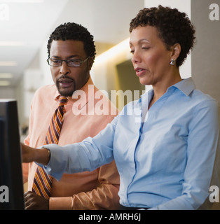African businesspeople looking at computer Stock Photo