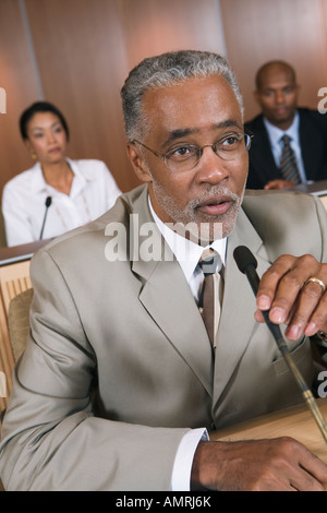 african businessman speaking into microphone Stock Photo