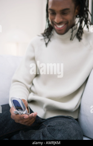 African man looking at cell phone Stock Photo