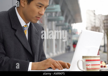 Businessman Using Laptop Computer At Cafe Stock Photo