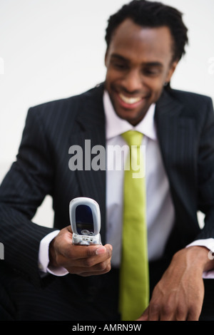 African businessman looking at cell phone Stock Photo