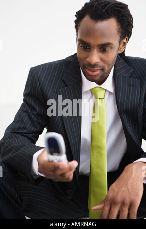 African businessman looking at cell phone Stock Photo