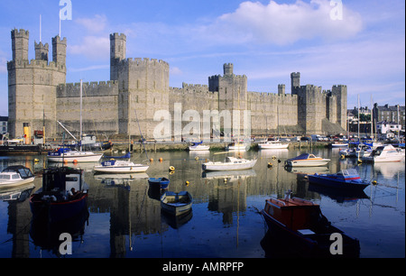 Caernarfon Castle Wales Medieval fortress Welsh architecture 13th century Edward 1st first history towers battlements river boat Stock Photo