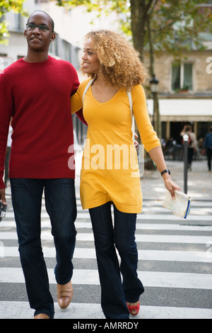 African couple walking across street Stock Photo