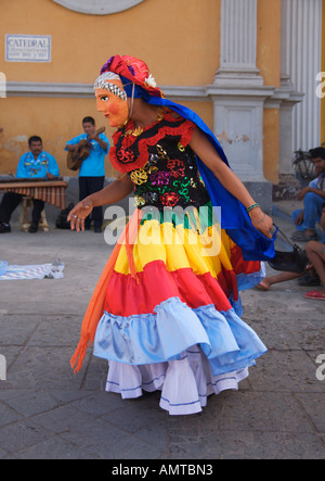 Masked local girl female folk dancer in costume full skirt swirling in Granada city Republic of Nicaragua Central America Stock Photo