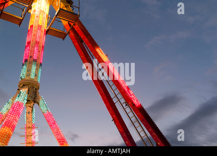 Abstract detail of brightly lit fairground ride against an evening sky - Aberystwyth November fair Stock Photo