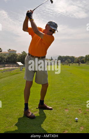 Man teeing off at the Oliva Nova Golf Course, Club de Golf Oliva Nova, an 18 hole golf Course in the town of Oliva Nova Stock Photo