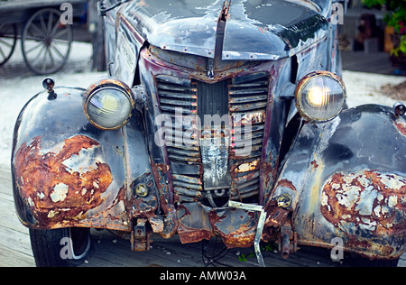 Rusted, decrepit, beat up, falling apart antique Ford automobile Stock Photo