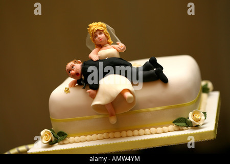 Humorous bride and groom wedding cake decoration Stock Photo