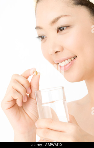 Woman who takes a supplement Stock Photo