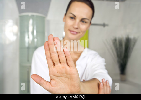 young woman putting on nail-polish Stock Photo