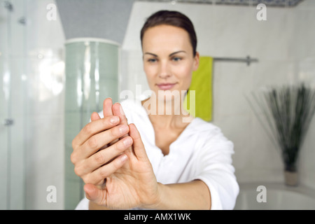 young woman putting on nail-polish Stock Photo