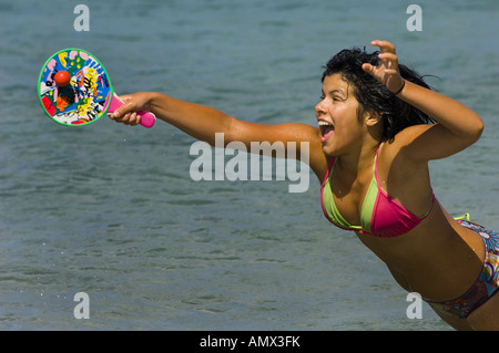 young woman playing beach ball on the beach Stock Photo
