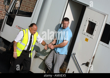 Prisoner escorted to court by prison van, Britain, UK, face has been obscured. Stock Photo