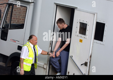 Prisoner escorted to court by prison van, Britain, UK, face has been obscured. Stock Photo