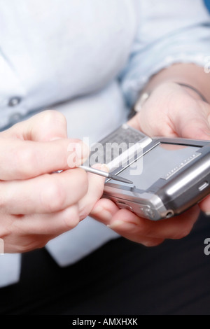 Close-up of woman's hands using palmtop Stock Photo