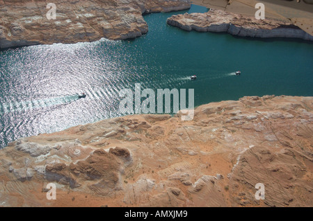 Houseboats create wakes on the surface of Lake Powell in Arizona Stock Photo