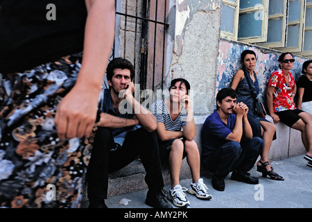 Shoppers waite in line for stores to open on a sidewalk in Holguin n Cuba Stock Photo