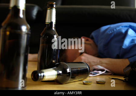 Alcoholic Man Lying On Floor With Beer Bottles In Kitchen Stock Photo ...