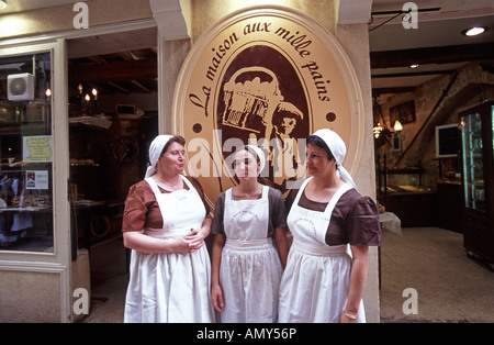 Three female bakers outside Sommieres most famous bakery where bread is made in a traditional way Gard Languedoc Roussillon, Occitania, France Stock Photo