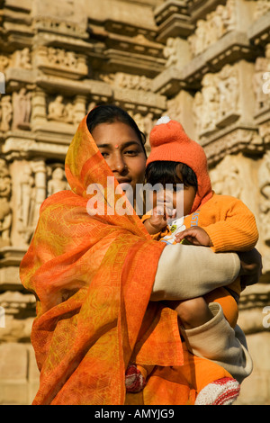 Woman with child in front of the Parsvanath Temple in Khajuraho in Madhya Pradesh State India Stock Photo